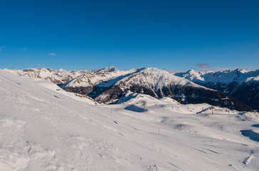 January 2020 Sillian, Austria: snowy ski run on the foreground, blue sky on the background
