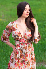 Pretty woman in summer dress posing outdoors