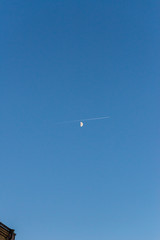 Airplane passing in fron of the moon in the evening
