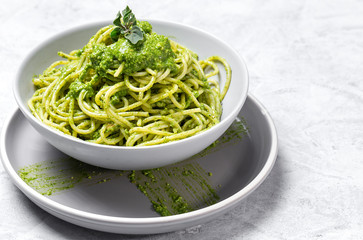Spaghetti with homemade pesto sauce on gray background