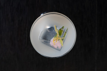 Cocktail with lime and flower inside the cube