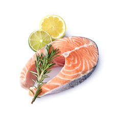 Salmon fish on white background with fresh  rosemary and citrus fruits.  Steak with lemon and lime isolated.