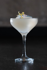 Cocktail with lime and flower inside the cube