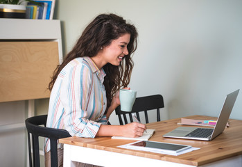 Smiling woman working from home stock photo