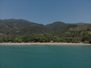 Beautiful island a tropical paradise beach with blue sea and wonderful landscapes, in the middle of the Atlantic forest, Drone Shot