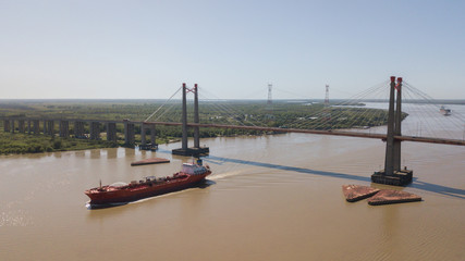 Long Arm Zarate Bridge, located in South America, Argentina, divides the province of Buenos Aires and Entre Rios. below this ship, cargo ships to Brazil and other destinations.