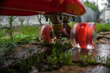 red children's skateboard in the grass
