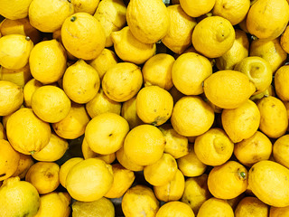 lots of ripe citrus yellow lemons to eat like a background