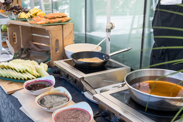 Candy bar food buffet by the pool, during hotel brunch, catering ,Chef live pancakes cooking station