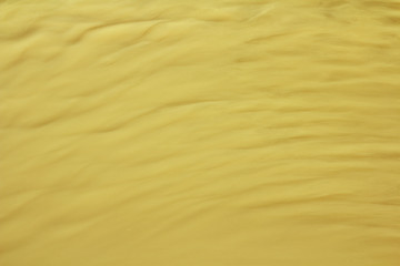 Yellow wavy striped background. Waves and ripples on the water. Place for text and design.
