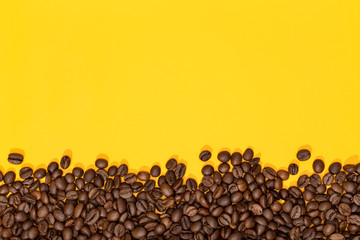 Coffee beans on yellow background. Coffee background border. Copy space