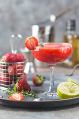 Ice Strawberry alcohol cocktail with lime and rum in a glass