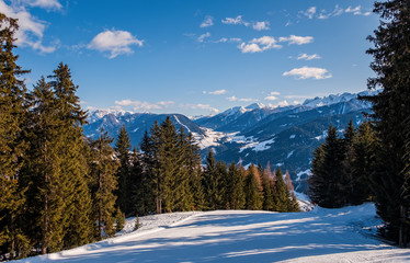 Fototapeta na wymiar January 2020 Sillian, Austria: snowy ski run on the foreground, blue sky on the background