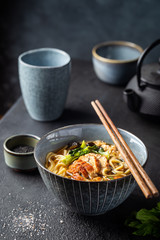 japanese soup with fried eel Yanagawa Nabe in a bowl on dark background