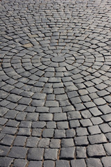 Cobblestone pavement close up pattern on old town street. Rough stone pavement, empty cobbled city road with no people. Cobble stone street detail, empty paved avenue and pathway closeup view