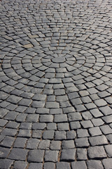 Cobblestone pavement close up pattern on old town street. Rough stone pavement, empty cobbled city road with no people. Cobble stone street detail, empty paved avenue and pathway closeup view