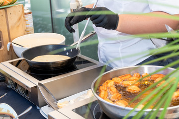 Candy bar food buffet by the pool, during hotel brunch, catering ,Chef live pancakes cooking station