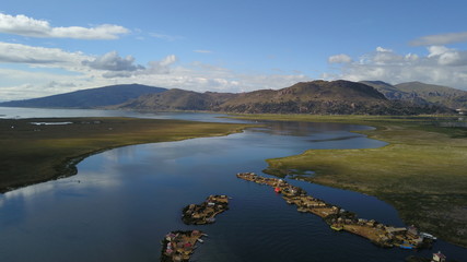 Lake Titicaca in Puno in Peru, view from drone and floating islands of the Uros people in the background