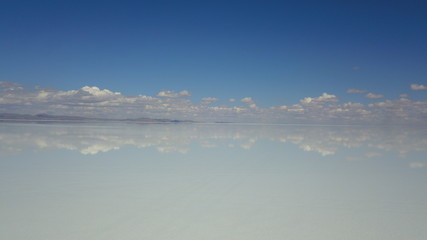 Salar de Uyuni, Salt desert in Bolivia, seen with drone and Andes in the background