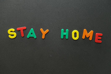 The inscription STAY HOME on a dark background