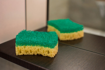 sponge and liquid soap on the bathroom shelf background