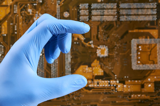 mockup of a technician person with latex blue gloves over circuit board background.  give or hold gesturing.