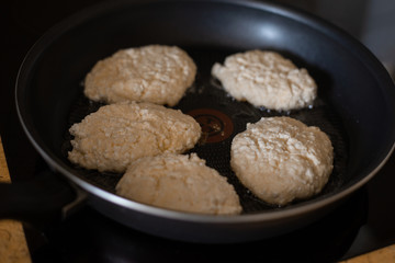 homemade cheesecakes are fried in a frying pan, the process of cooking homemade cheesecakes