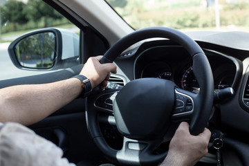 Male hand of driving car. 