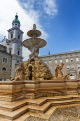 Fototapeta na wymiar Horse fountain in front of Cathedral in the old town of Salzburg by day, Austria