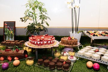 Large assortment of desserts, muffins, cakes, tarts. Candy bar wedding reception brunch buffet