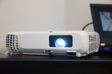 LCD video projector at business conference or lecture in office with copy space. projector on ceiling indoors. LCD video projector at business conference or lecture in office with copy space .