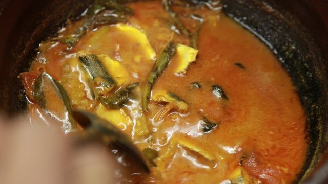 Meen Vattichathu or Pattichathu, sardine fish cooked. Traditional hot and spicy fish curry Kerala India with dried red chilly and green curry leafs. Very popular coastal food eat with tapioca or rice