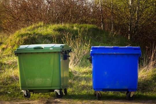 two garbage containers stand in the village