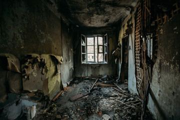 Fototapeta na wymiar Burnt house interior. Consequences of fire concept