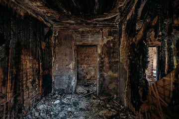 Burnt and collapsed old house interior. Consequences of fire