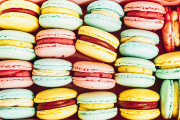 Sweet almond colorful pastel pink blue yellow green macaron or macaroon dessert cake background. French sweet cookie. Minimal food bakery concept. Flat lay top view, copy space