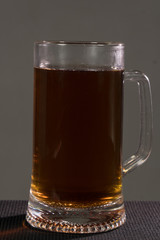 Glass beer on wood background with copyspace