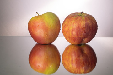 red apple on mirroring table. Gorizontal image with copy space.