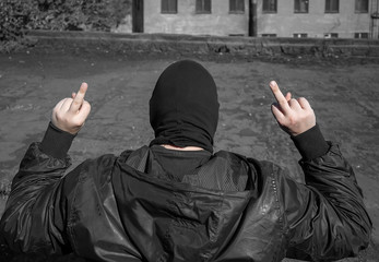arrest of the criminal, the bandit raised his hands and demonstratively shows a fingers on his hands