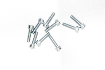 Top view of hexagon socket Bolts. Pile of stainless steel bolts on bright white background with silver color with copy space. 3d illustration