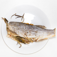Grilled spicy fish isolated on bright white background with silver color, top view