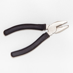 Used pliers isolated on bright white background with silver color, top view