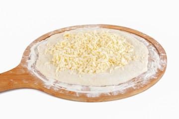 Dough for Georgian traditional food khachapuri on a wooden dish on white