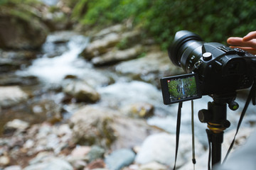 Photographer make video of waterfall deep in forest