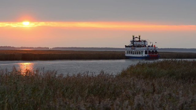Wheel paddle boat with bird watchers at the Darss Peninsula Bodden Water, Germany, watching crane birds in autumn
