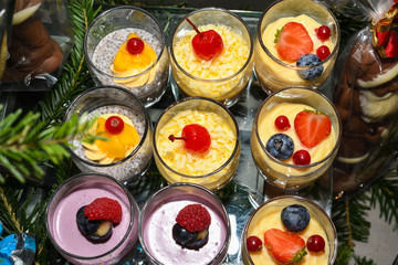 Various desserts in candy bar food buffet during hotel brunch, catering, cake pops, mousse, tarts