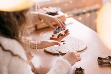 Young mother and her little daughter baking ginger cookies together at home kitchen. Flat lay photo.