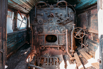 Fototapeta na wymiar Old steam engine of abandoned steam locomotive Inside driving cabin
