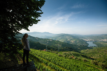 Female on the hill looks at on of the Douro Valley, Porto, Portugal. - obrazy, fototapety, plakaty