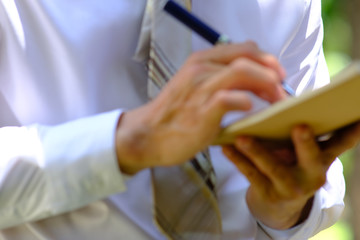 Fototapeta premium businessman writing on a notebook and successful planning